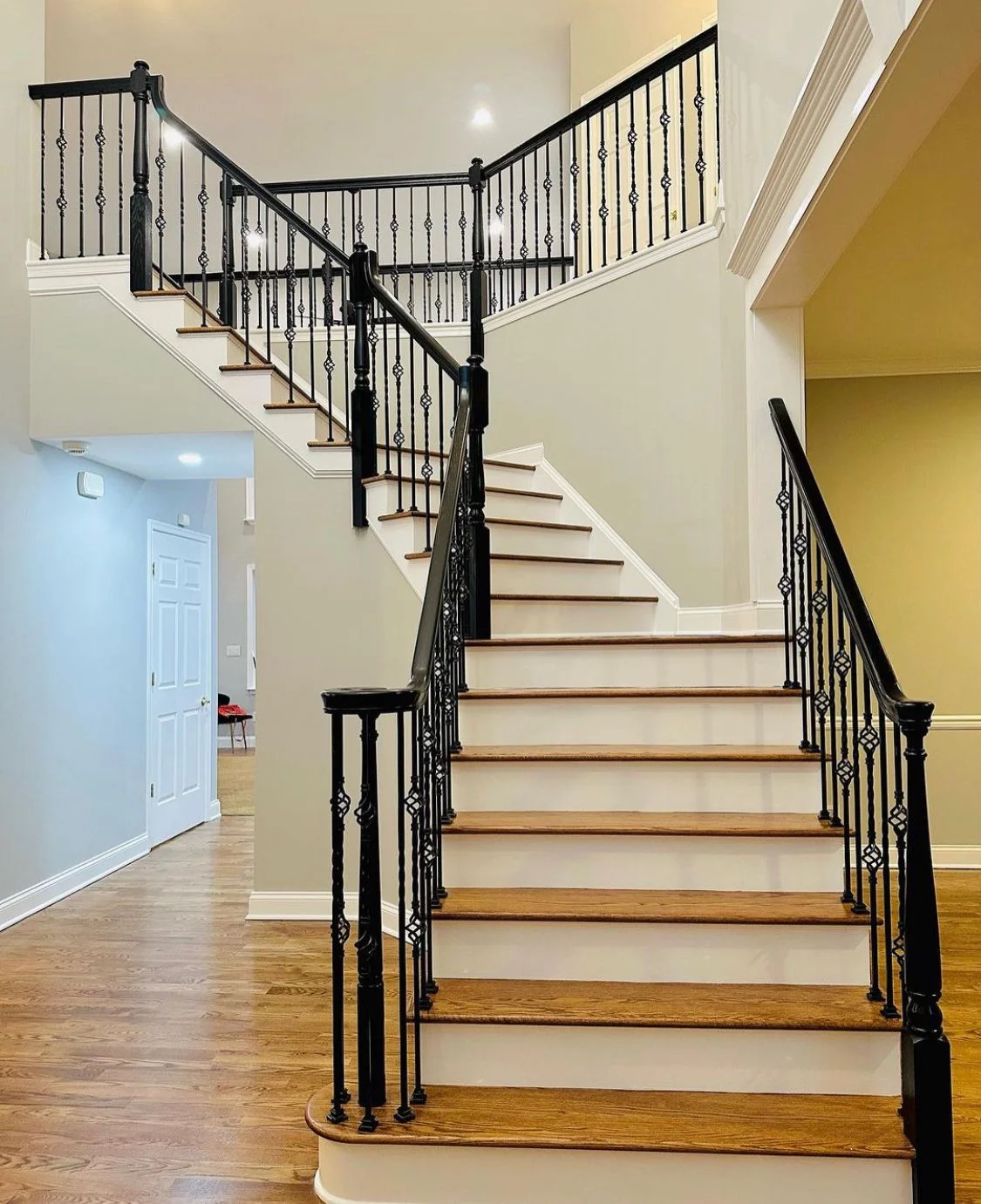 Renovated interior staircase with wood treads and dark railings